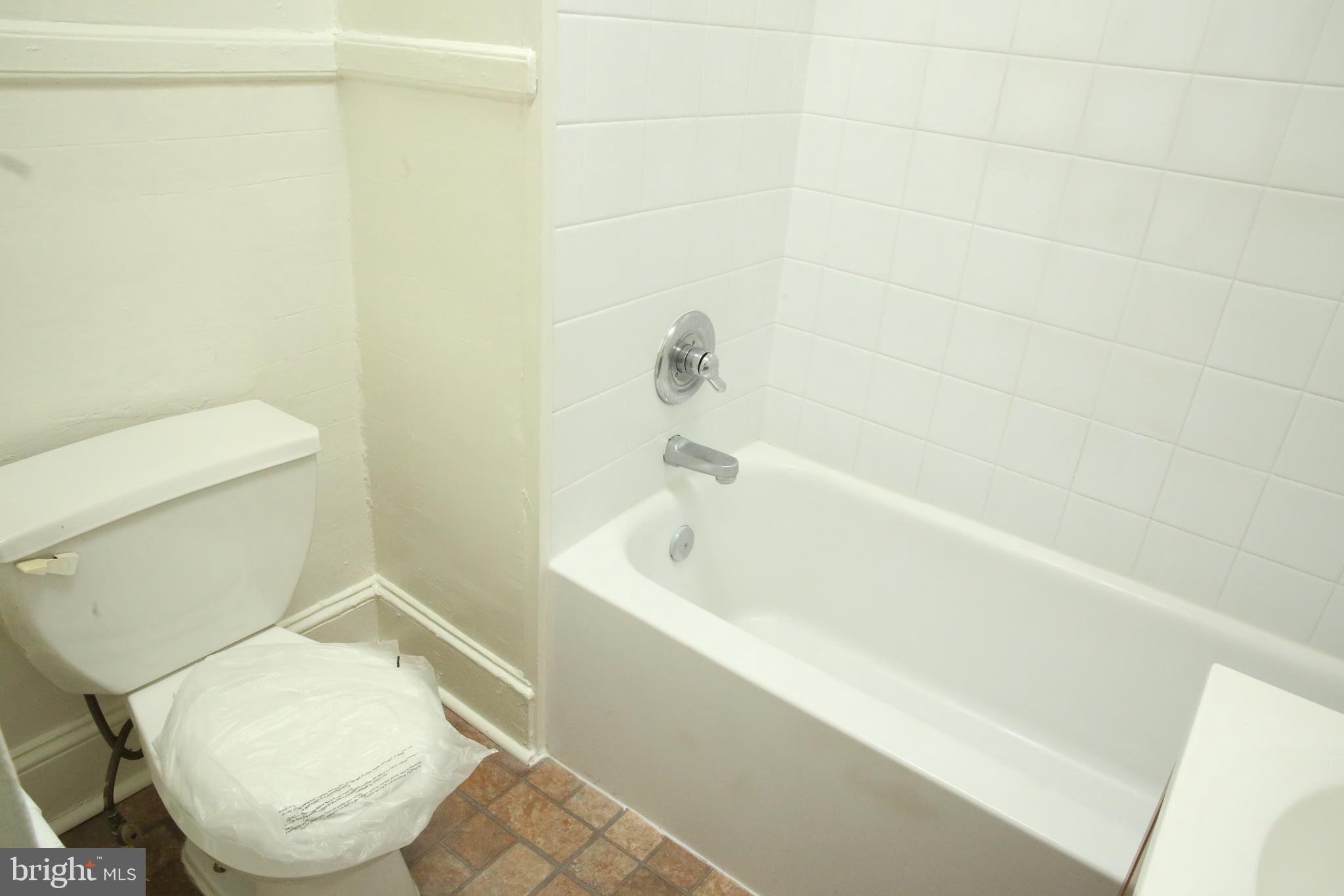 4852 Pimlico Road Baltimore, MD 21215 - Photo 24 of 40 a white toilet sitting next to a bath tub