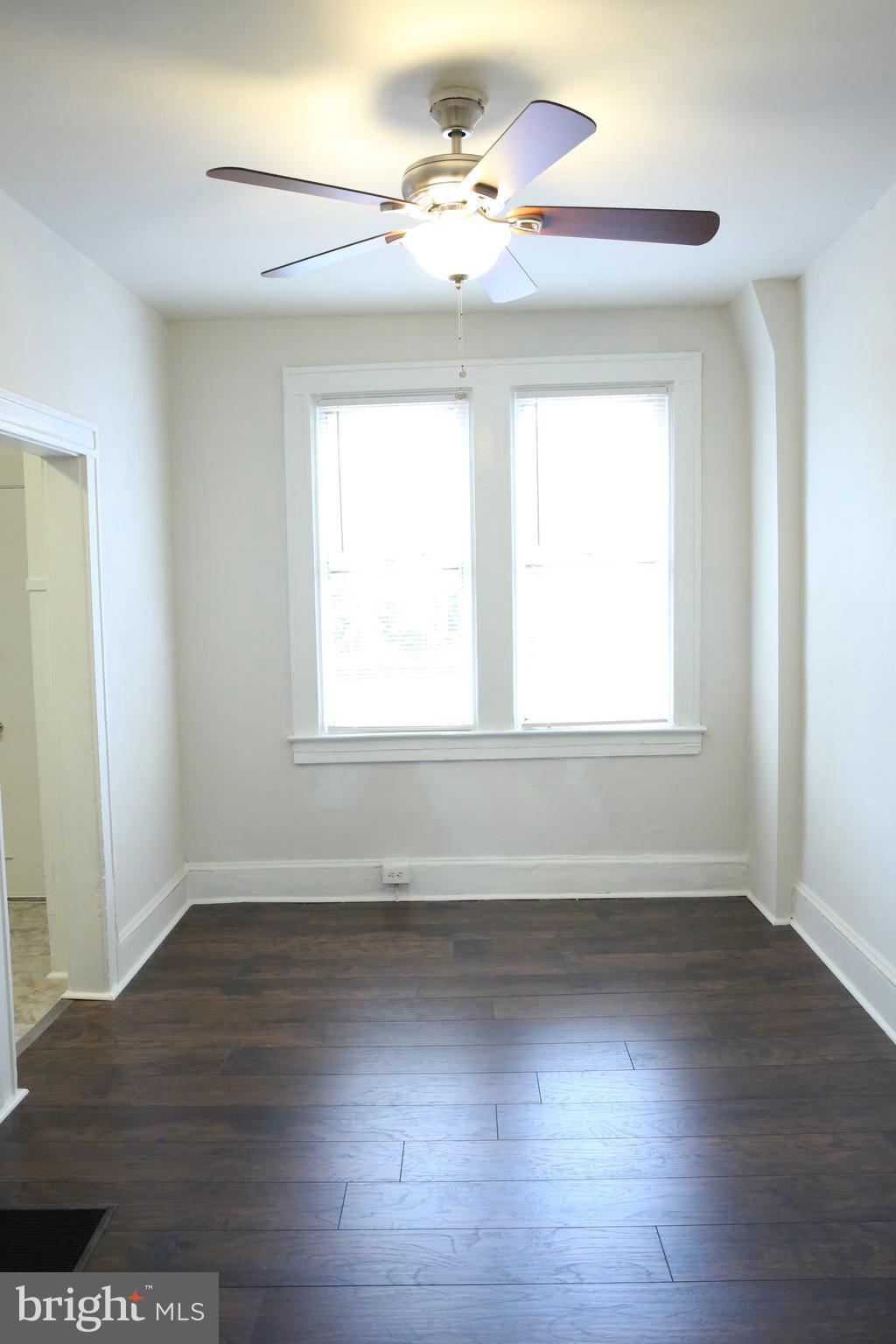 4852 Pimlico Road Baltimore, MD 21215 - Photo 6 of 40 a view of empty room with wooden floor and fan