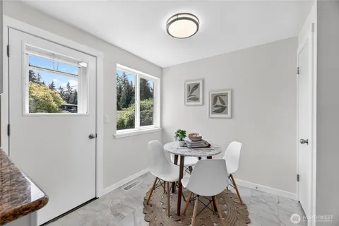 a dining room with furniture and window