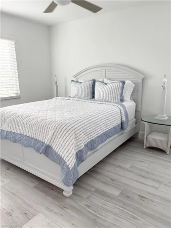 a bedroom with a bed and a night stand