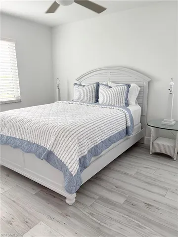 a bedroom with a bed and a night stand