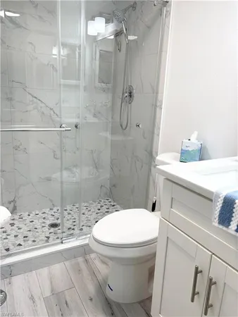 a bathroom with a sink toilet and shower
