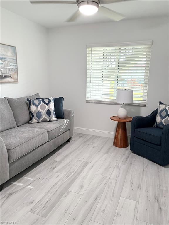 4351 27th Court Southwest, Unit 104 Naples, FL 34116 - Photo 8 of 16 a living room with furniture and windows