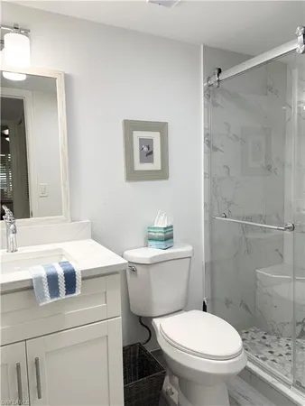 a white toilet sitting next to a bathroom sink