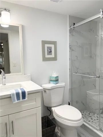 a white toilet sitting next to a bathroom sink