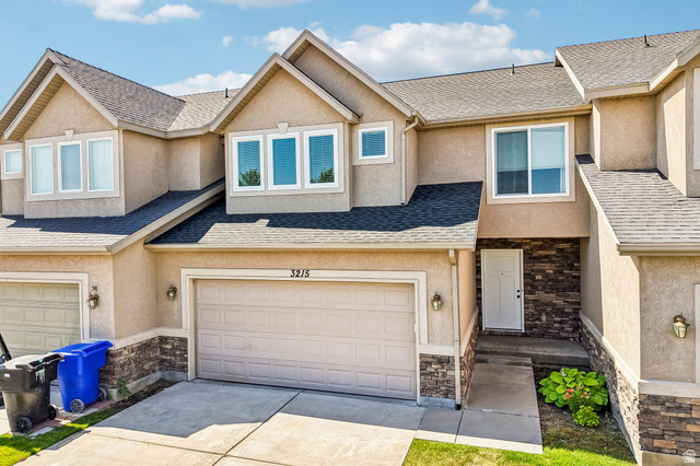 3215 West 450 North West Point, UT 84015 - Photo 2 of 40 Stucco exterior featuring a single-car garage and stone veneer accents