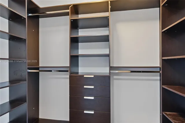 a view of walk in closet with empty racks