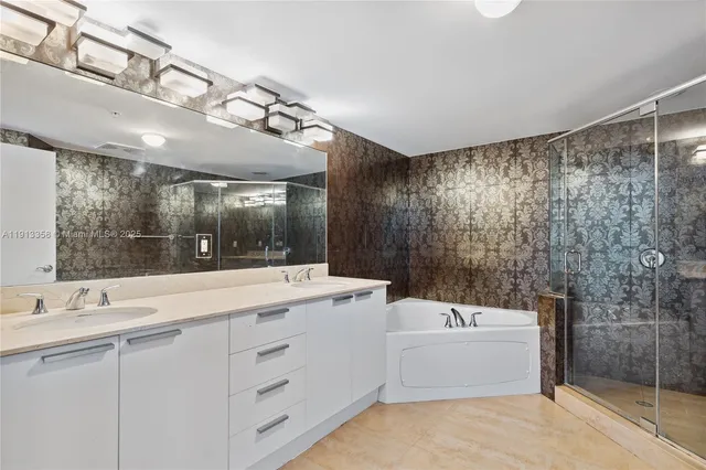 a bathroom with a sink double vanity mirror and a bathtub