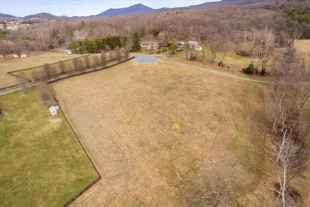 a view of a dry yard with mountains in the background