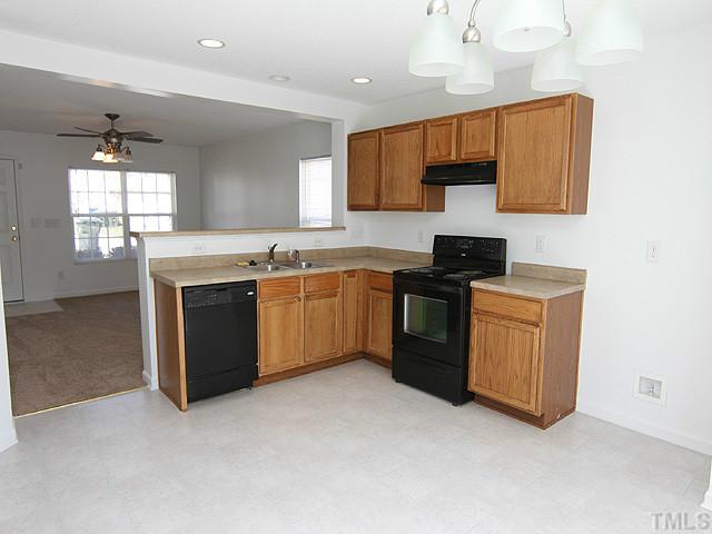 3734 Marshlane Way Raleigh, NC 27610 - Photo 4 of 12 a kitchen with a sink cabinets and window