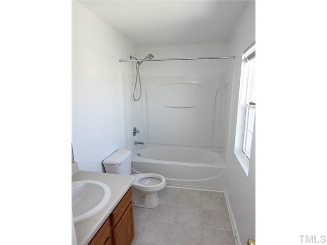 3734 Marshlane Way Raleigh, NC 27610 - Photo 7 of 12 a bathroom with a tub a sink and toilet