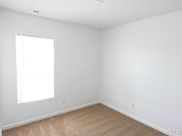 3734 Marshlane Way Raleigh, NC 27610 - Photo 8 of 12 an empty room with a window