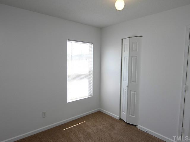 3734 Marshlane Way Raleigh, NC 27610 - Photo 9 of 12 an empty room with windows and closet