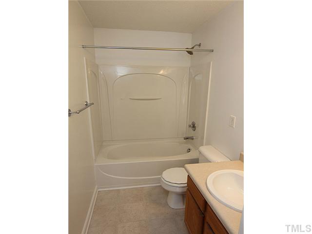 3734 Marshlane Way Raleigh, NC 27610 - Photo 10 of 12 a bathroom with a granite countertop bathtub shower sink mirror vanity and toilet