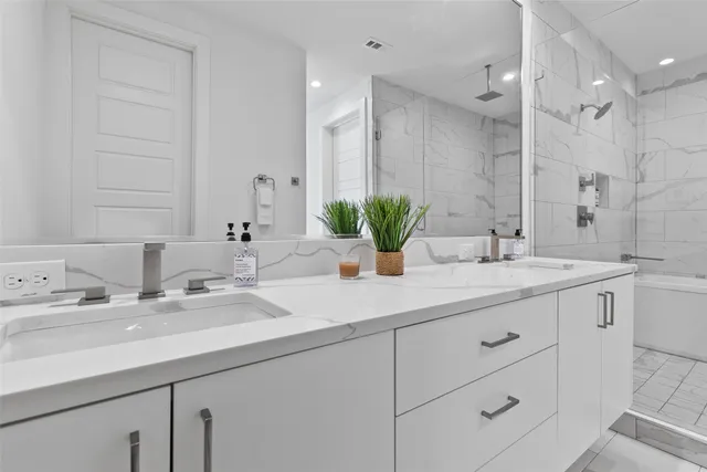 a bathroom with double sink and a mirror
