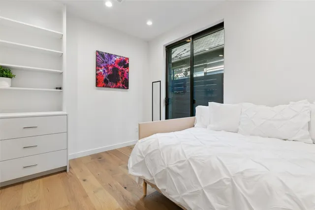 a bedroom with a bed and a window