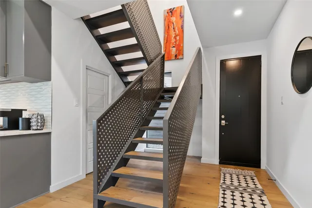 a view of entryway with wooden floor and stairs