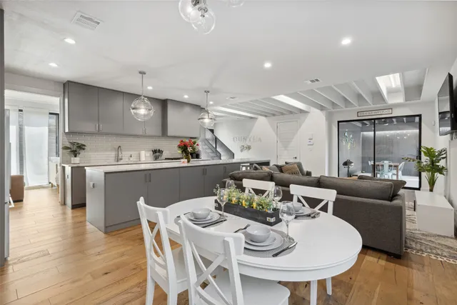 a kitchen with kitchen island a dining table and chairs