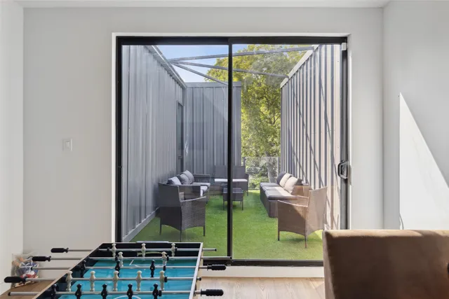 a room with pool table and windows