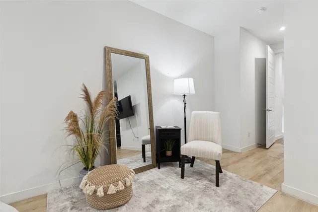 a living room with furniture rug and a lamp