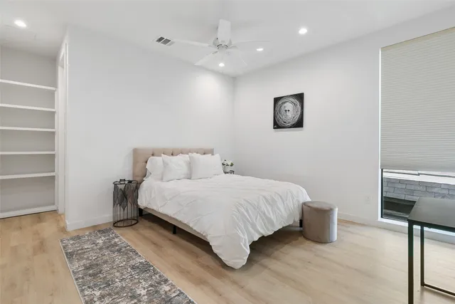 a bedroom with a bed and a window