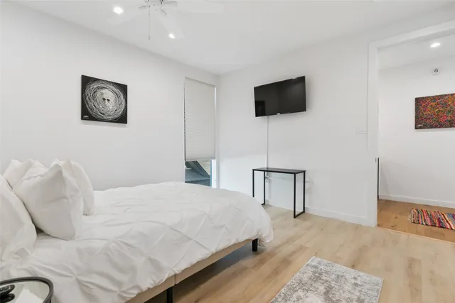 a bedroom with a bed and a flat screen tv