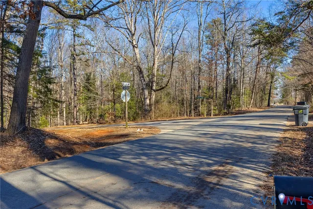 a view of a road with a wrought fence