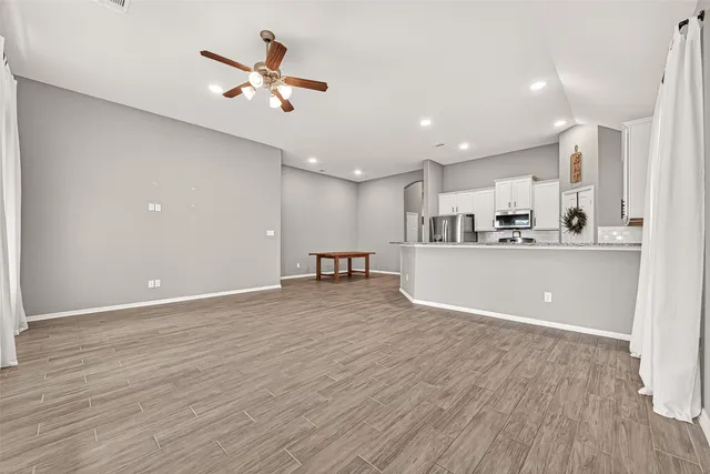 a view of a kitchen with a sink cabinets and wooden floor