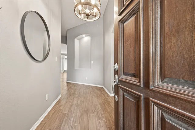 a view of a room with wooden floor and a window