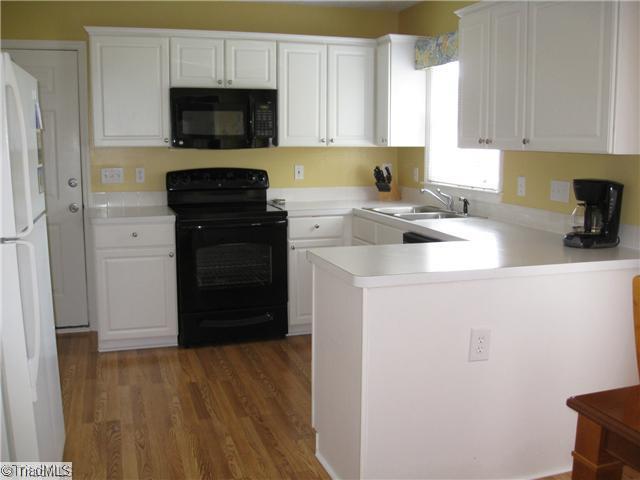 4225 Braddock Road High Point, NC 27265 - Photo 4 of 16 Kitchen. The large sunlit kitchen has tons of cabinet and counter top space plus a built-in pantry. Brand new wood flooring installed in the foyer, hall, kitchen, breakfast, and powder rooms.