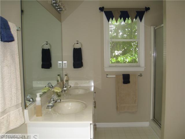 4225 Braddock Road High Point, NC 27265 - Photo 8 of 16 Master Bath/Spa. Lovely master bath complete with double bowl vanity, walk-in shower, and soaking tub with tile surround.