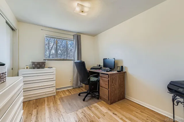 a view of a workspace with furniture and wooden floor