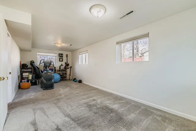 a view of a room with lots of gym equipment