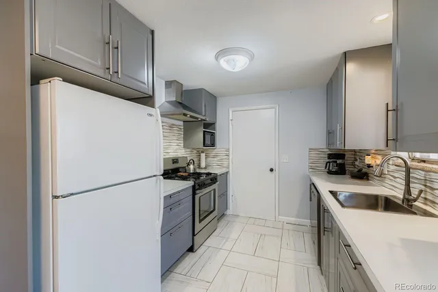a kitchen with a sink a stove and refrigerator