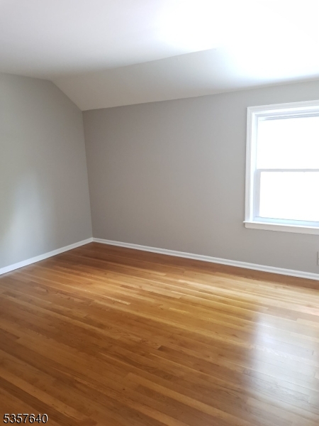 67 Canfield Road Morristown, NJ 07960 - Photo 12 of 21 a view of an empty room with wooden floor and a window