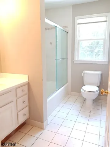 a bathroom with a toilet a sink and a window