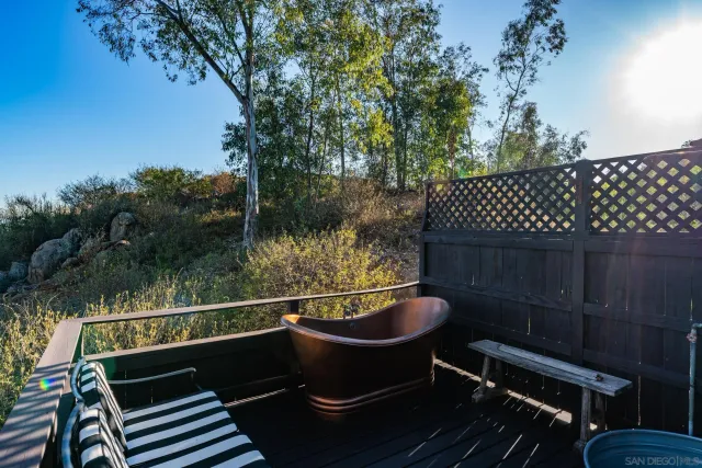 a view of a roof deck with couches and wooden floor
