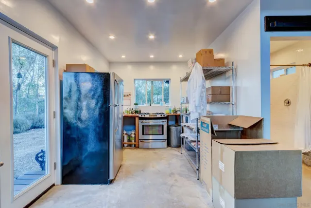 a kitchen with stainless steel appliances granite countertop a refrigerator and a stove