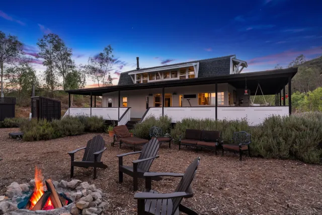 a backyard of a house with table and chairs