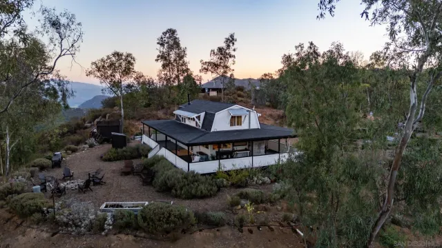 a view of a house with a yard and sitting area