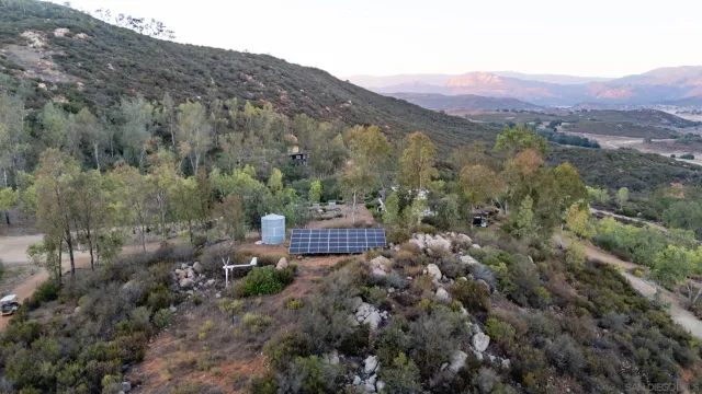 a view of a lush green hillside and houses