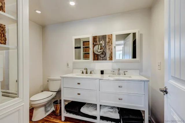 a bathroom with a toilet a sink and mirror