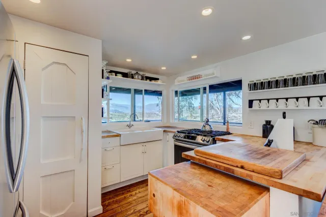a kitchen with a sink appliances and cabinets