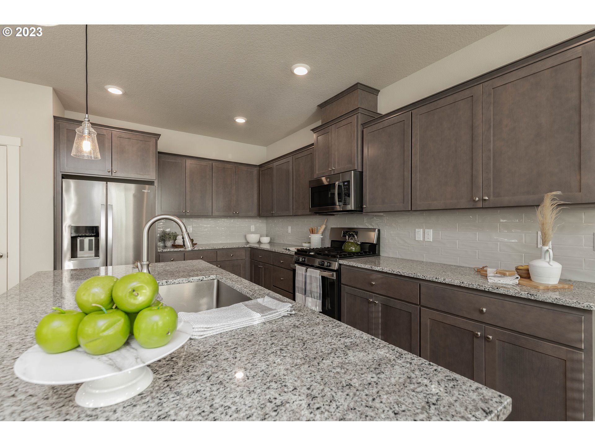 3825 South 39th Place Ridgefield, WA 98642 - Photo 15 of 37 a kitchen with a sink a stove and cabinets