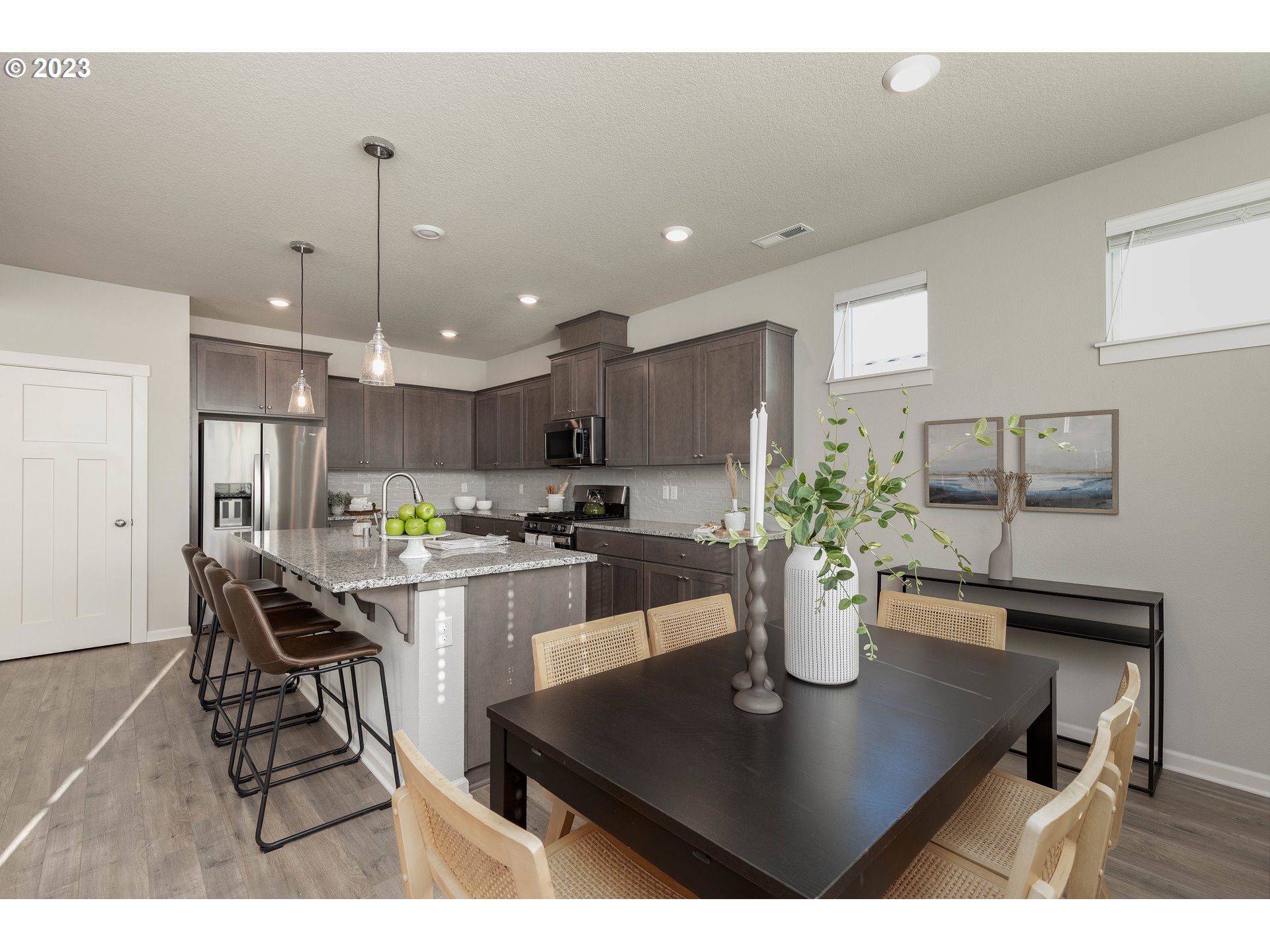 3825 South 39th Place Ridgefield, WA 98642 - Photo 16 of 37 a kitchen with a dining table cabinets and wooden floor