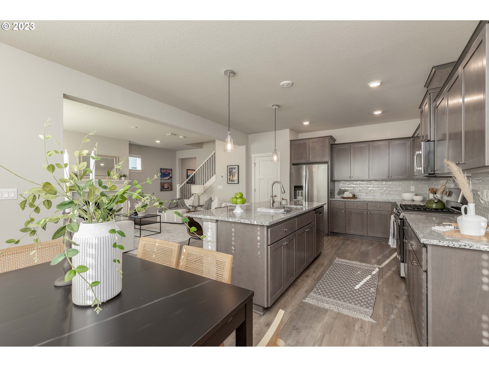 3825 South 39th Place Ridgefield, WA 98642 - Photo 18 of 37 a living room with kitchen island furniture and a wooden floor