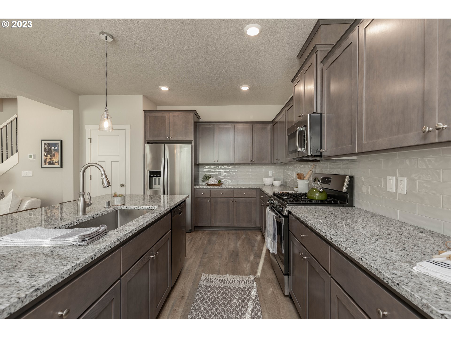 3825 South 39th Place Ridgefield, WA 98642 - Photo 19 of 37 a kitchen with stainless steel appliances granite countertop a sink a stove and refrigerator