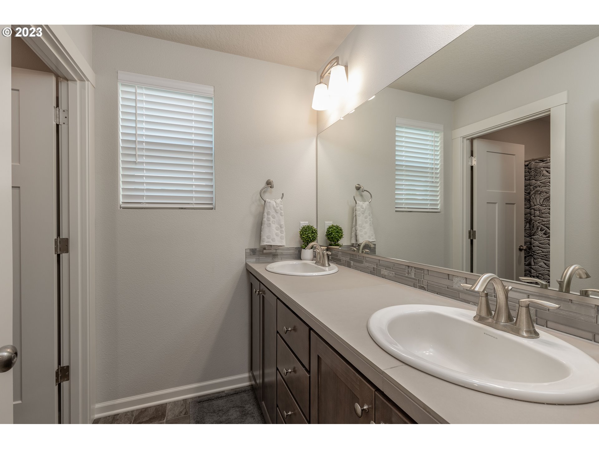 3825 South 39th Place Ridgefield, WA 98642 - Photo 26 of 37 a bathroom with a sink a vanity and a mirror
