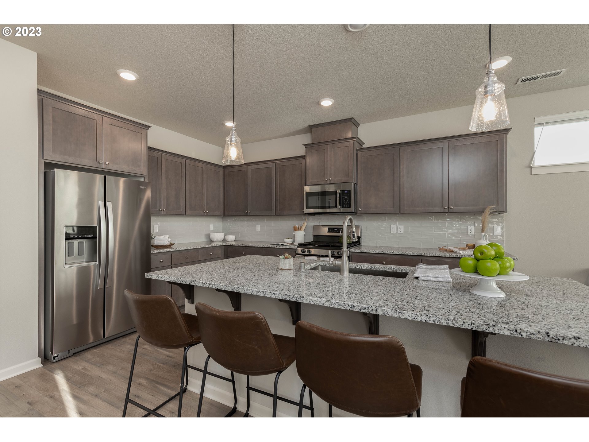 3825 South 39th Place Ridgefield, WA 98642 - Photo 7 of 37 a kitchen with stainless steel appliances granite countertop a sink refrigerator and cabinets