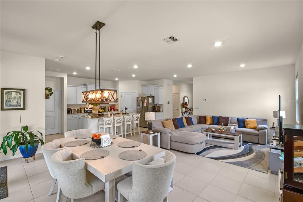 6345 Southwest 88th Loop Ocala, FL 34476 - Photo 14 of 41 a living room with furniture kitchen view and a chandelier